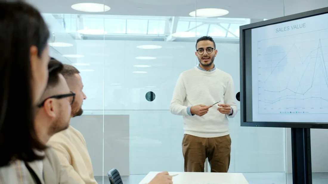 Presenter walking colleagues through results on a screen